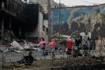 Des habitants passent devant un centre commercial endommagé à la suite des frappes russes à Kiev, le 25 mai 2026 - Tetiana DZHAFAROVA (AFP)