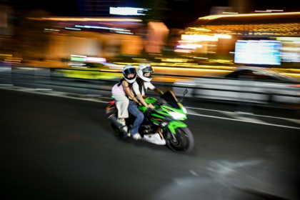 Deux femmes à moto dans une rue de Chongqing, dans le sud-ouest de la Chine, le 21 juillet 2026. - WANG Zhao (AFP)